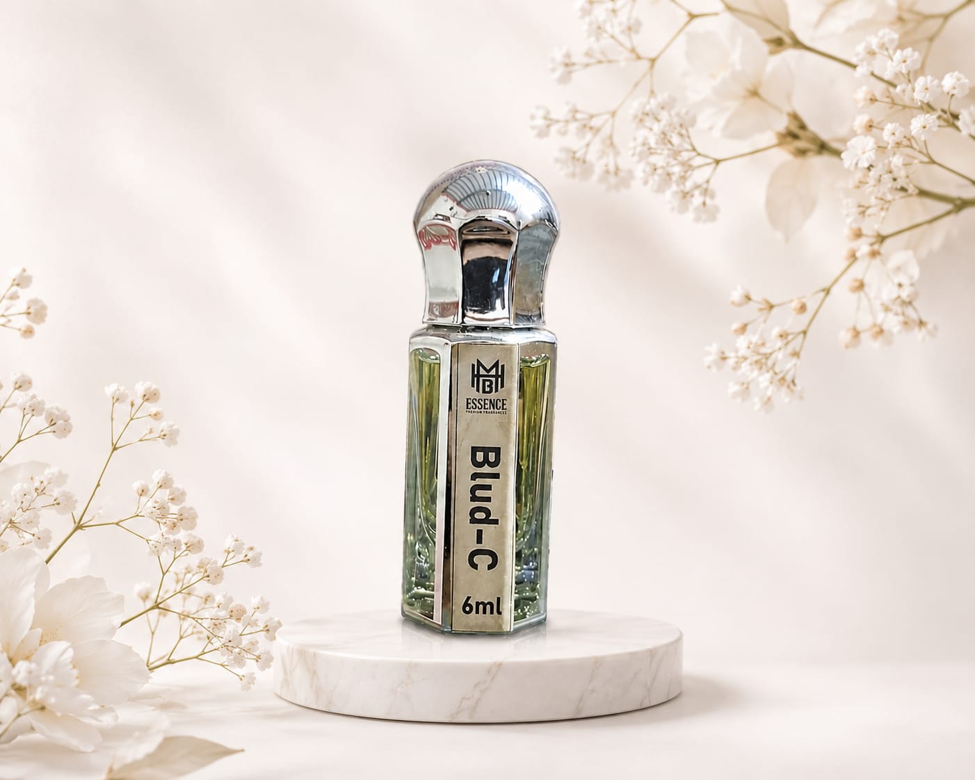 Blud-C premium perfume oil 6ml in luxury silver bottle with elegant floral background.